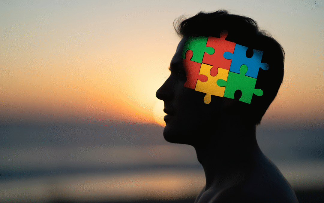 Silhouette humaine avec pièces de puzzle colorées symbolisant la santé mentale